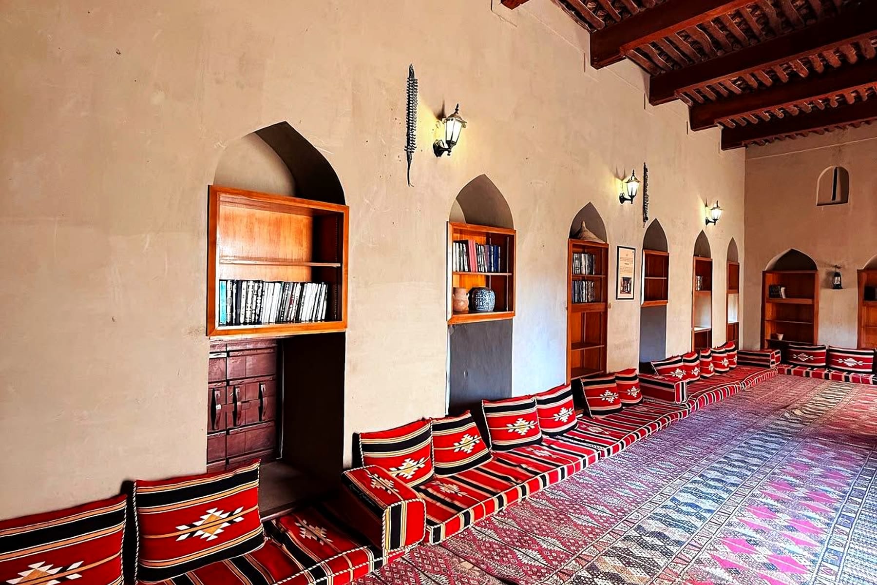 A traditional Omani majlis with heritage rugs and carved wood