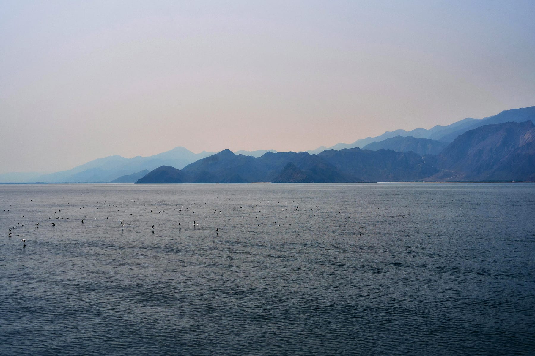 Dramatic Hajar rock formations at sunset