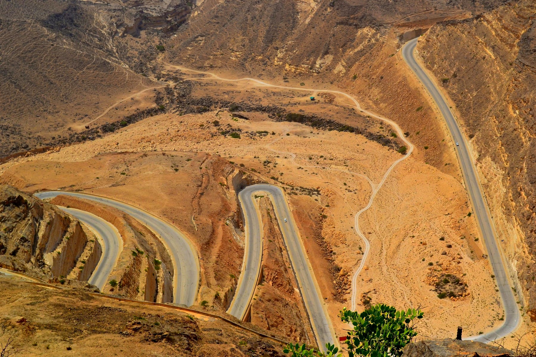 Winding desert road through the Hajar mountains